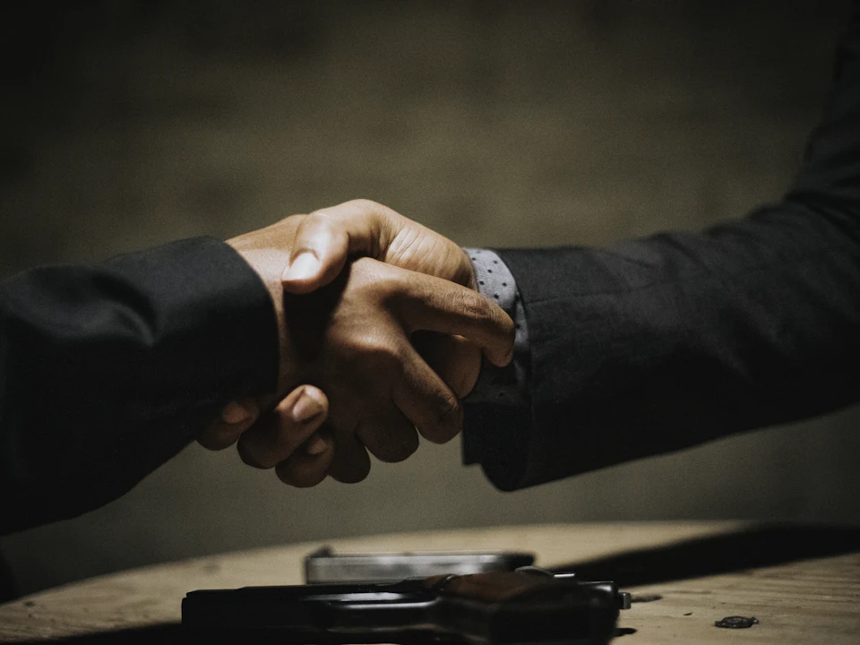 Two executives shaking hands after agreeing a partnership