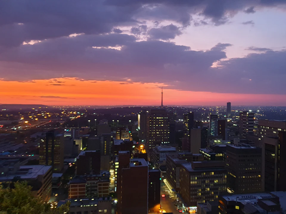 Johannesburg city at dusk under a purple sky