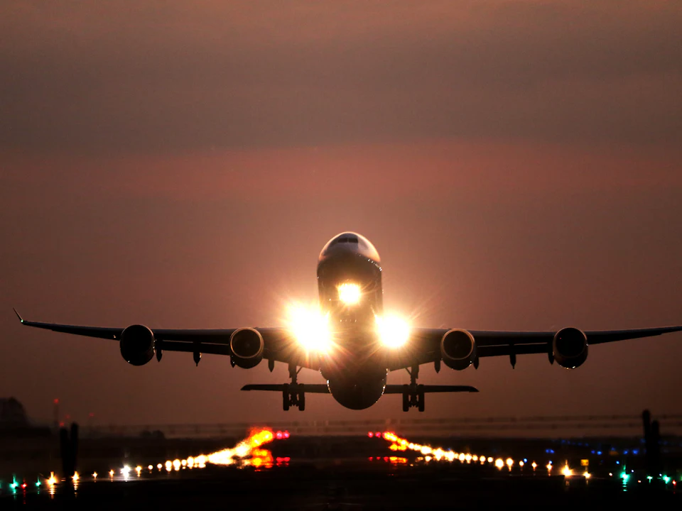 Cargo aircraft landing at sunset