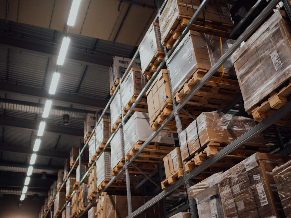 Warehouse aisles stacked with stock on pallets