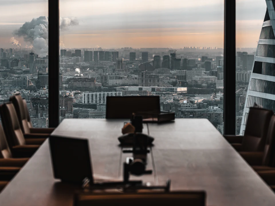High-rise executive boardroom overlooking the city skyline